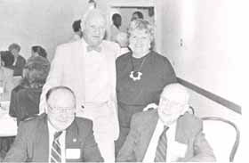 Lyle Reedy, Arlene Vandenberg (standing) greet Sen. Harlan Rigney, Mike Cassidy(seated)