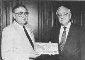 SPRINGFIELD  Robert Hermsmeyer (left) presents Secretary of State George Ryan with Litchfield's Desert Storm special event license plate #1. The plates are helping to welcome home local Desert Storm veterans at a special Fourth of July celebration.